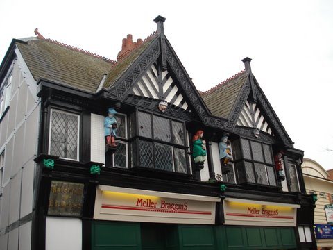 Restored Tudor shopfront with carved figures