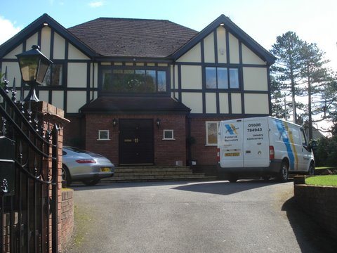 Tudor style house exterior decorated, with Peter Morgan van on the drive