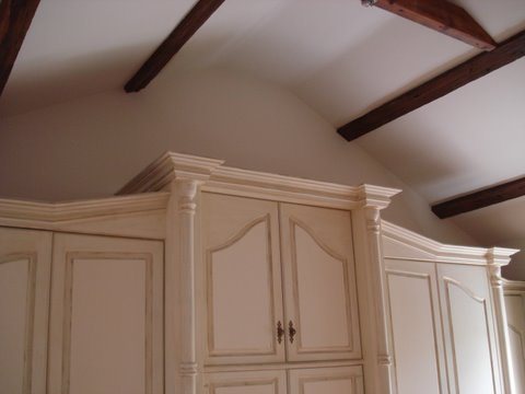 Hand painted fitted wardrobes under exposed beams